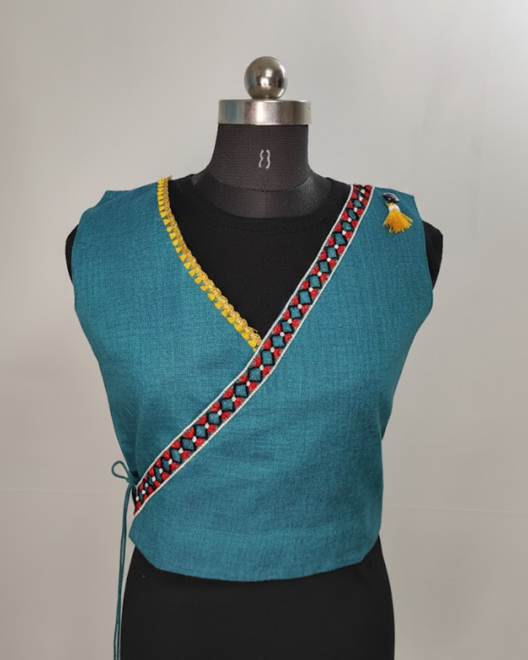 Wrap-style ethnic sleeveless blouse